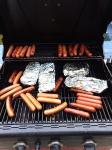 Keto Meat and Vegetable Foil Packets on grill with hot dogs