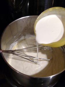 adding cream to cheese sauce