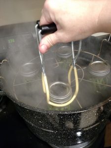 adding canning jar to canner